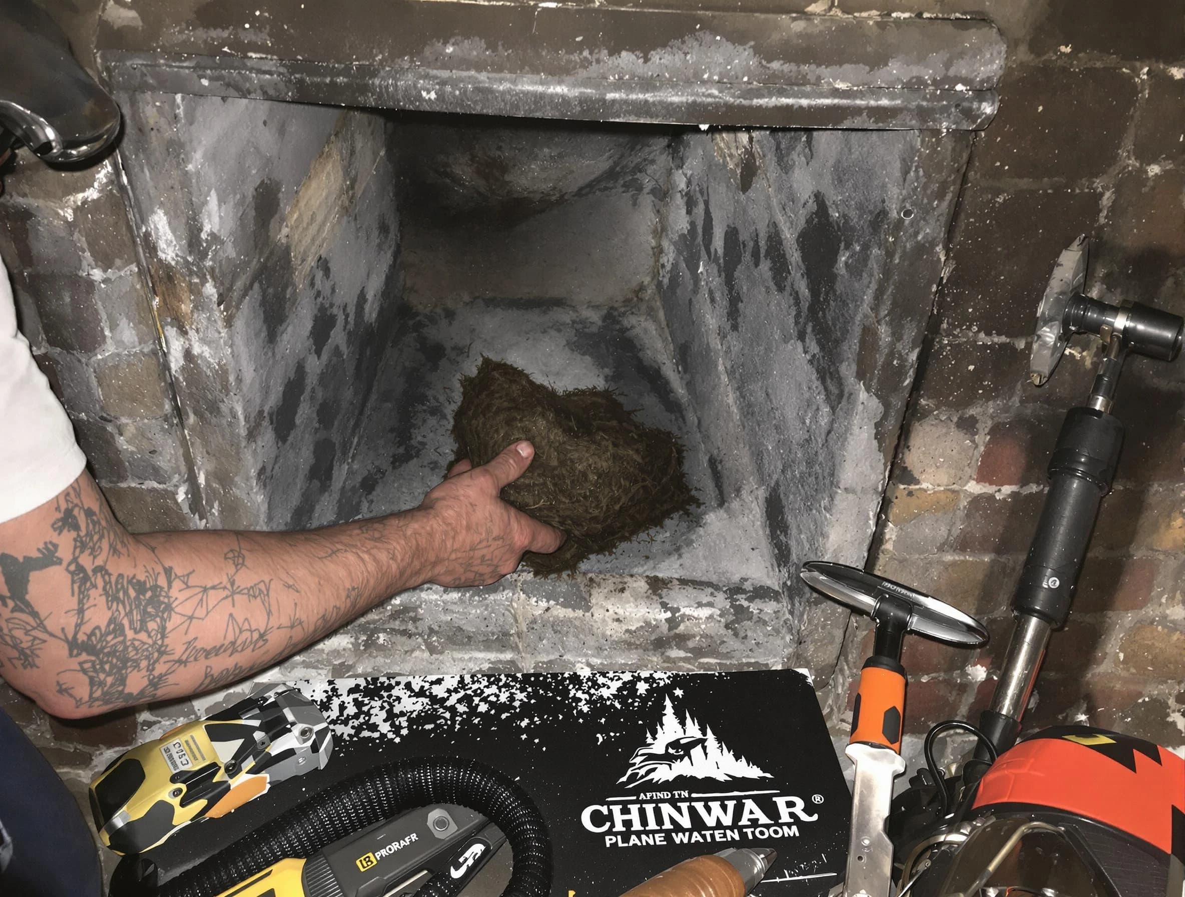 Fairfield Chimney Sweep safely removing debris and screening chimney in Fairfield, AL